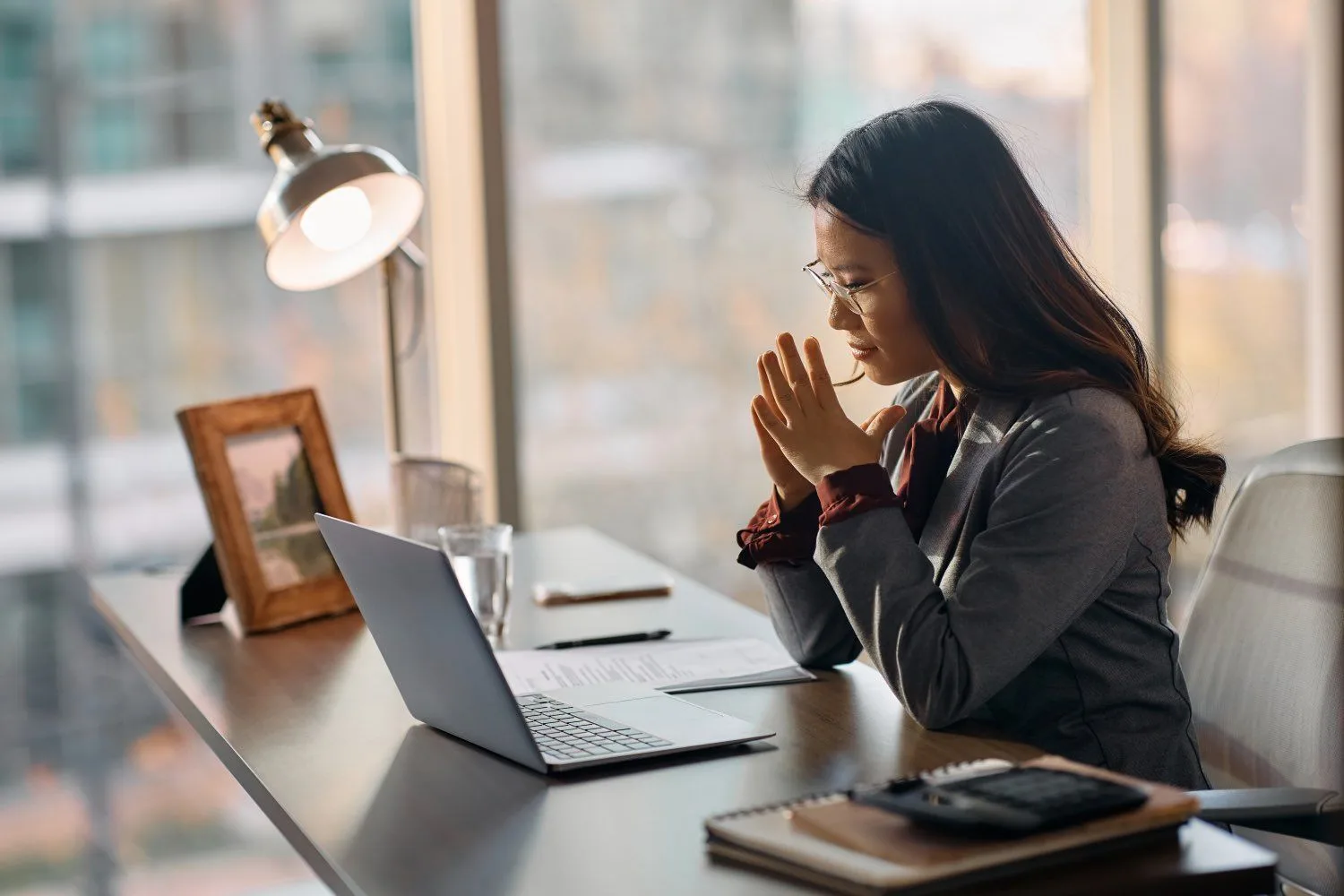 Person working at a laptop in a bright office