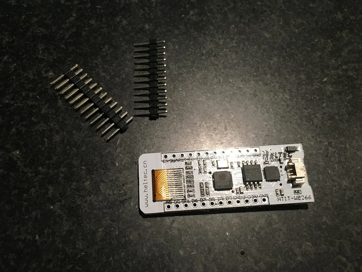 Underside of the ESP8266 WiFi Kit 8 board showing its chips and header pins