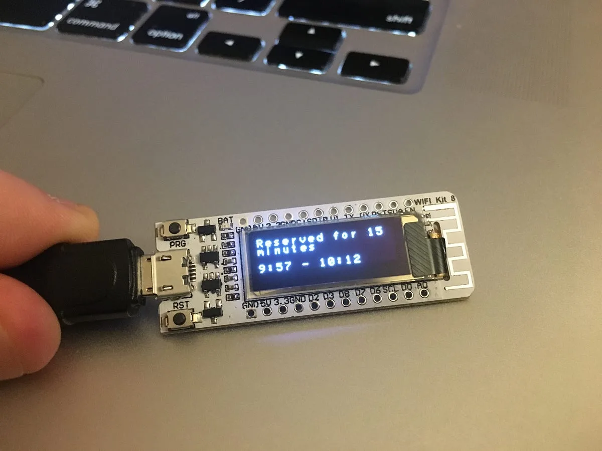 ESP8266 OLED display showing the room reserved for 15 minutes with the time range