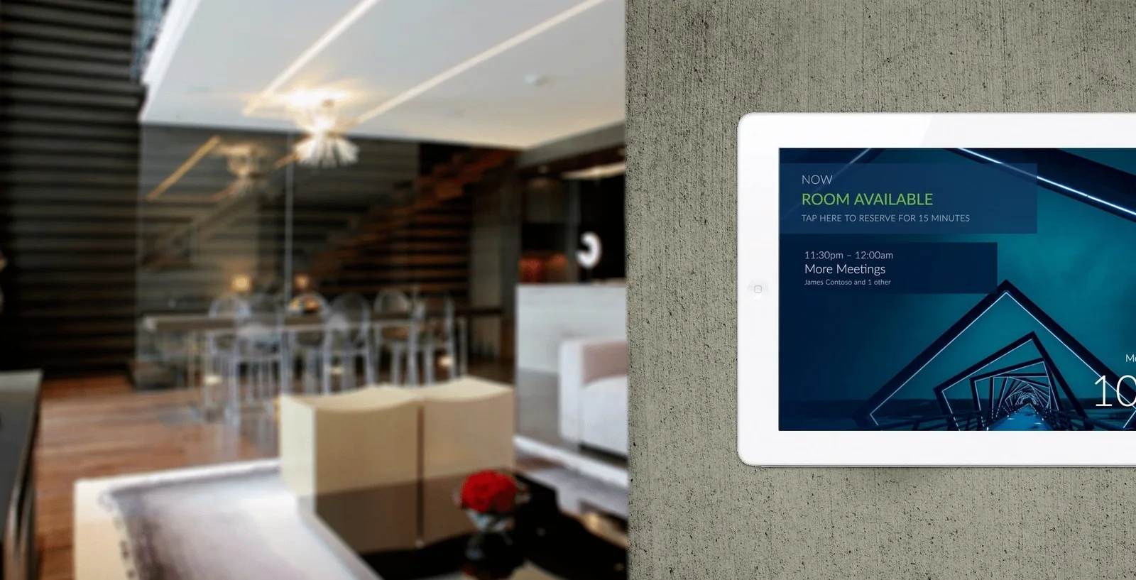 Tablet mounted on the wall outside a meeting room showing the room as available