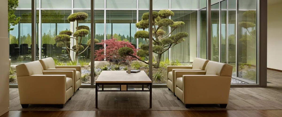 Nintendo office lounge with armchairs facing a landscaped Japanese garden