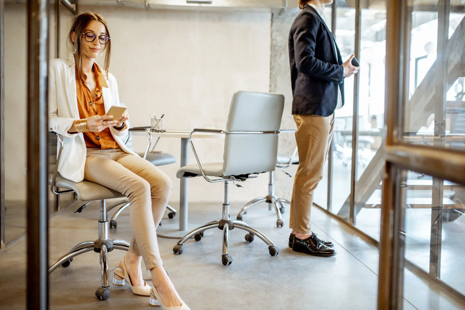 Two colleagues talking in a bright modern office