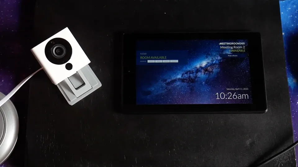 Wyze camera beside a meeting room display tablet